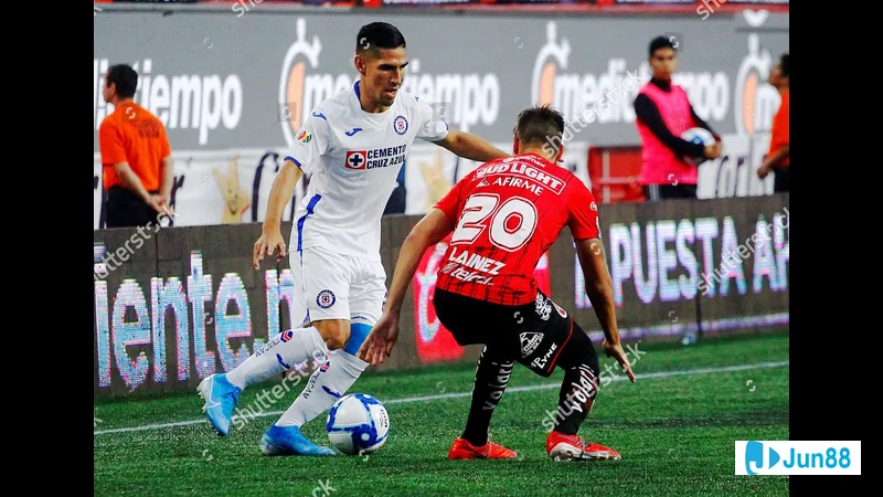 Cầu thủ Club Tijuana với áo đỏ đang tranh chấp quyết liệt với cầu thủ Cruz Azul với áo…